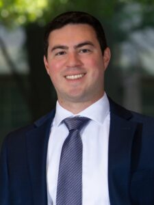 Andrew posing for his photo at Ryan Law firm.